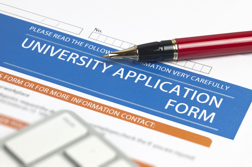 university application form with a pen